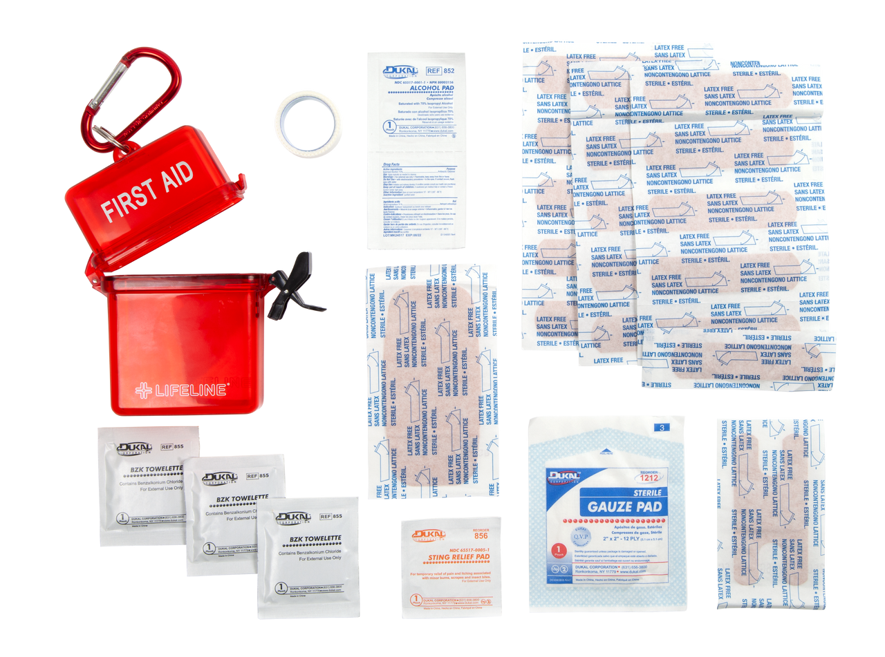 First aid kit with various supplies including bandages and a red container on a white background
