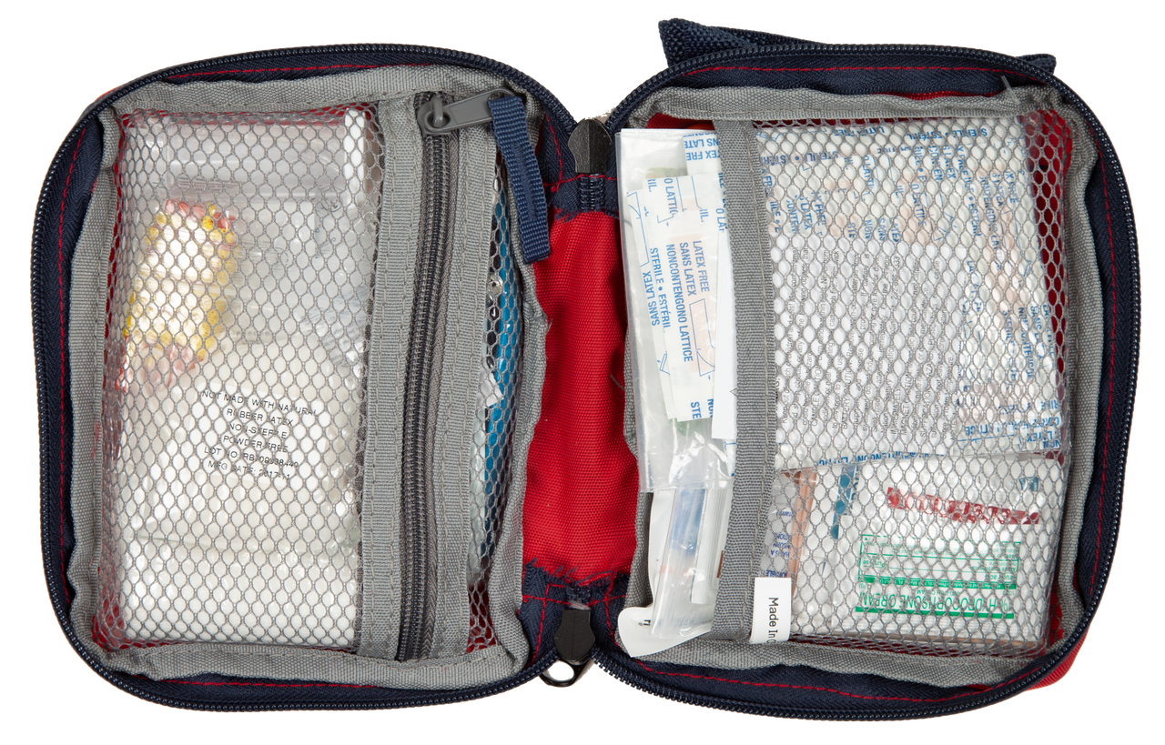 Open first aid kit with various supplies on a white background