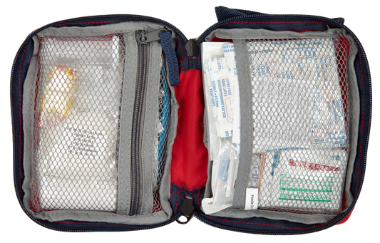 Open first aid kit with various supplies on a white background