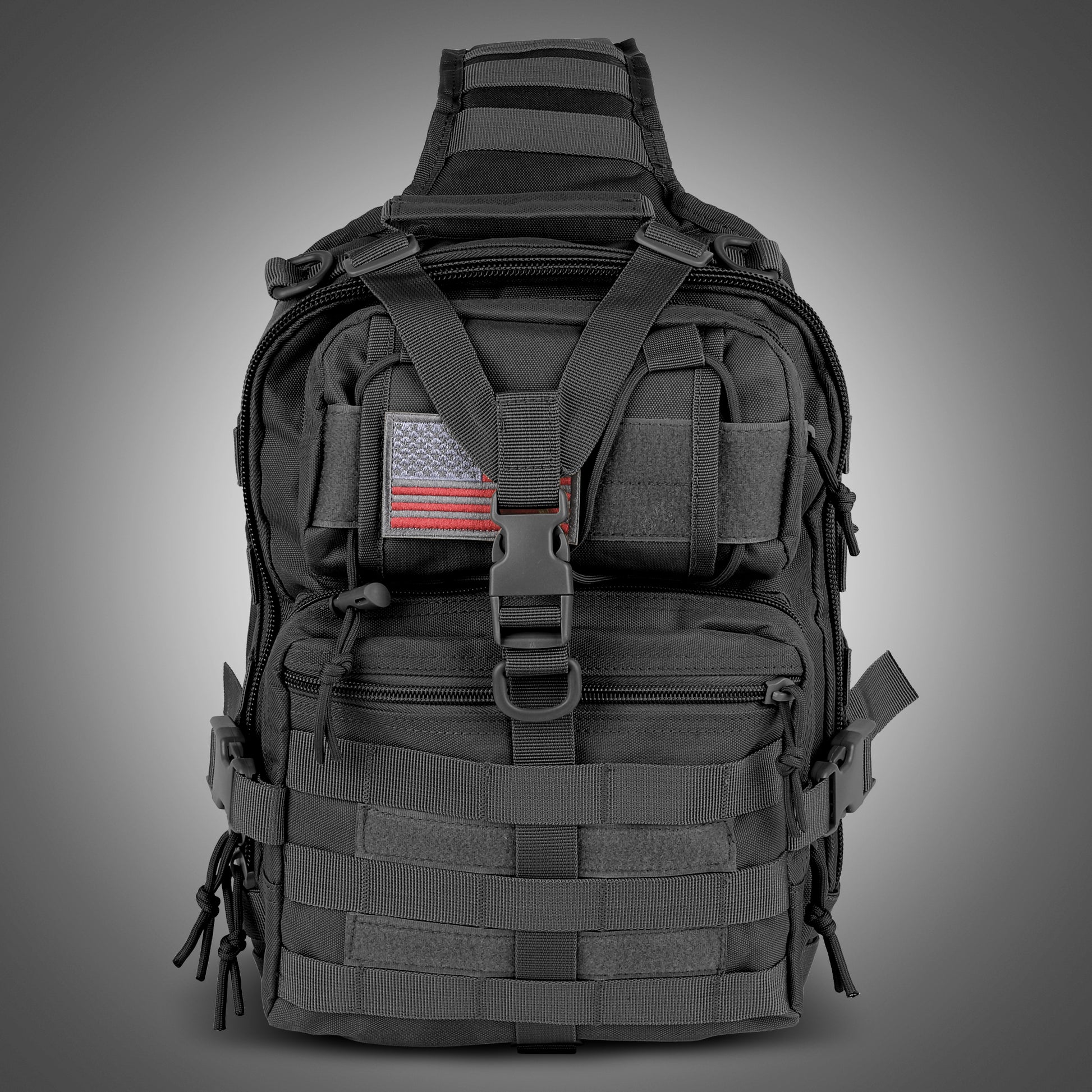Black tactical backpack with American flag patch on a gray background
